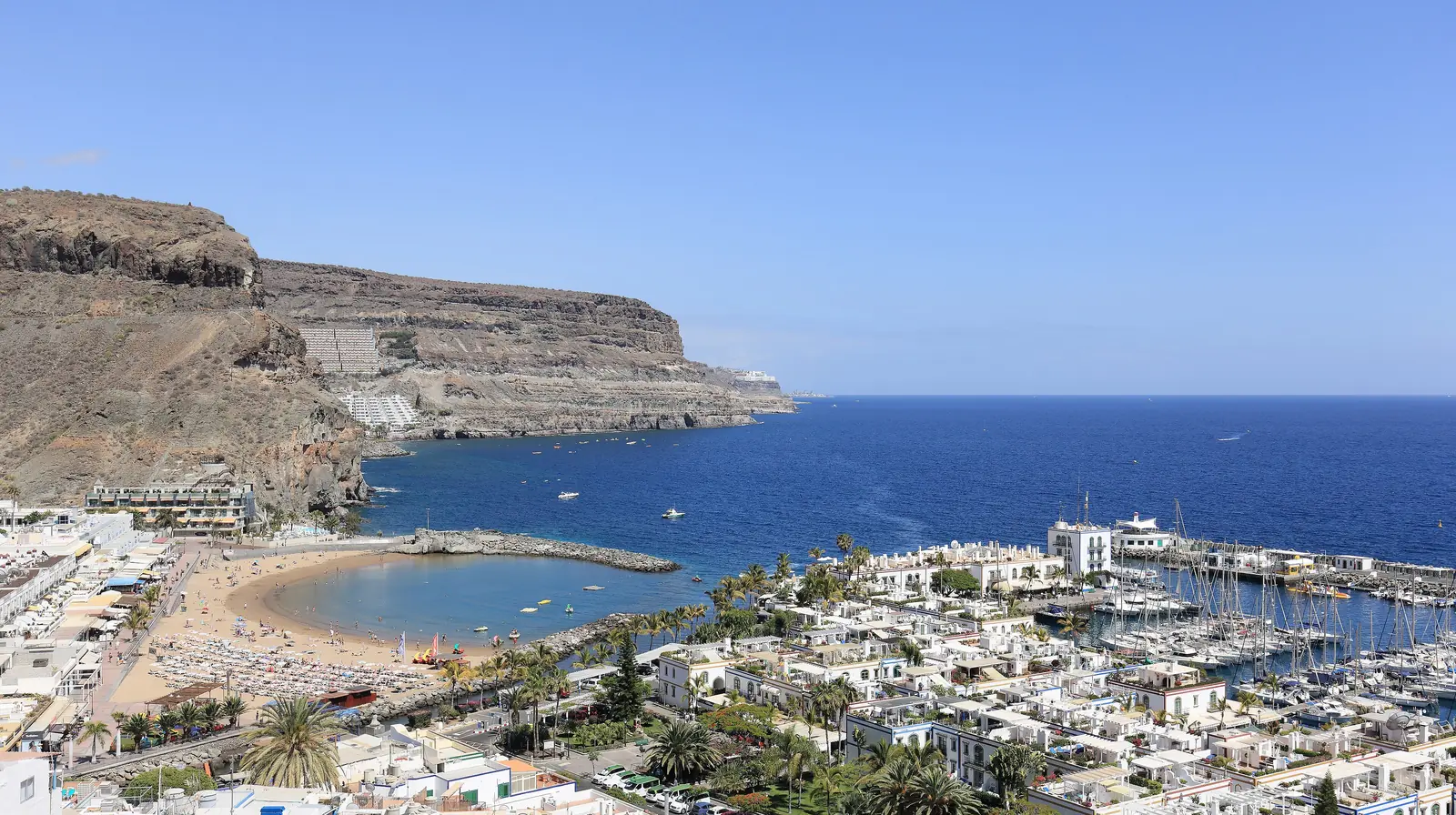 Puerto de Mogán seen from above, with its sandy beach, marina and white houses beneath the cliffs