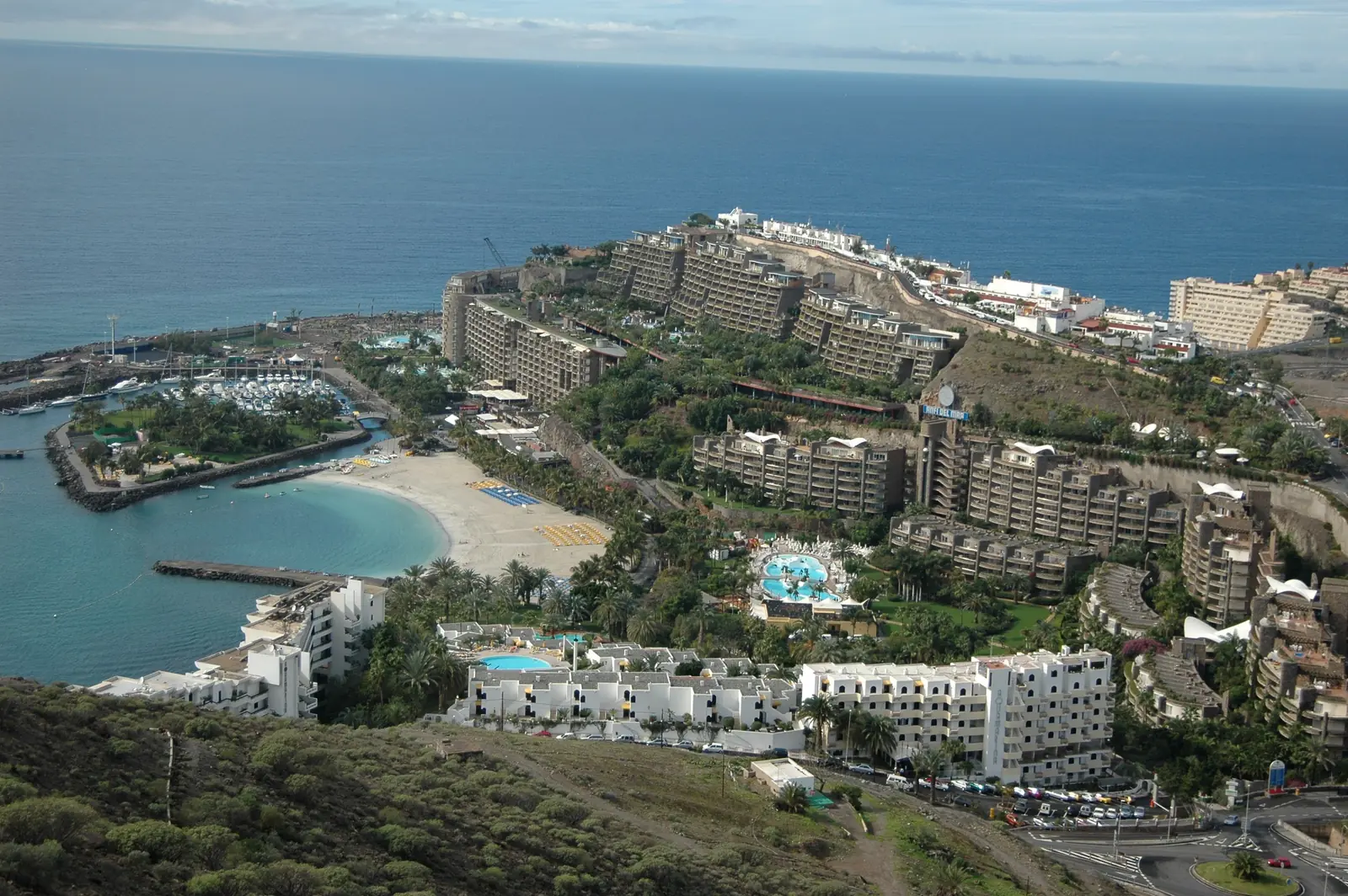 Aerial view of the Anfi del Mar resort, its marina and curved sandy beach on the Gran Canaria coast