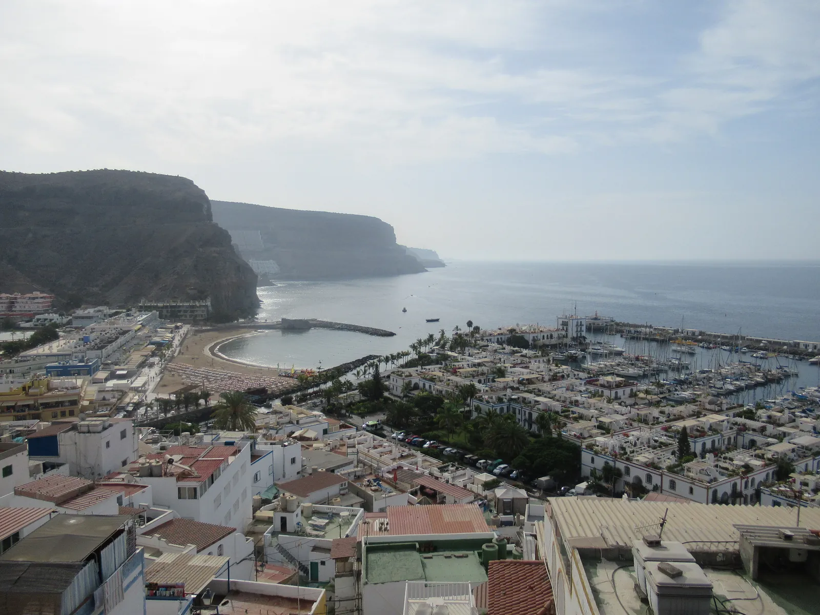 Puerto de Mogán seen from above, with its beach, marina and white houses beside the sea