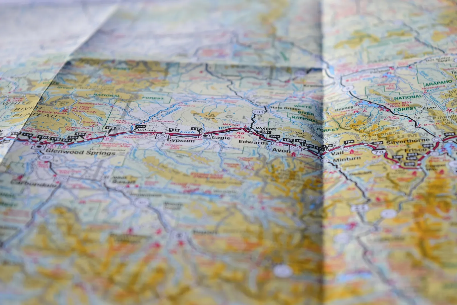 Folded road map spread out flat, showing routes and place names